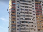 В Краснодаре мужчина повис на балконе между 11 и 12 этажом — очевидцы сняли видео